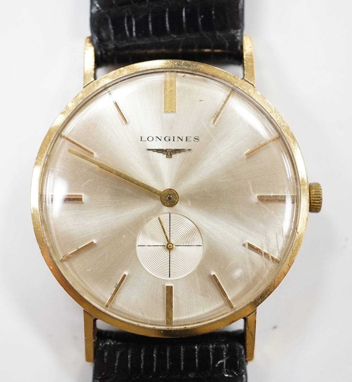 A gentleman's 9ct gold Longines manual wind wrist watch, with case back inscription, on associated leather strap. Condition - poor